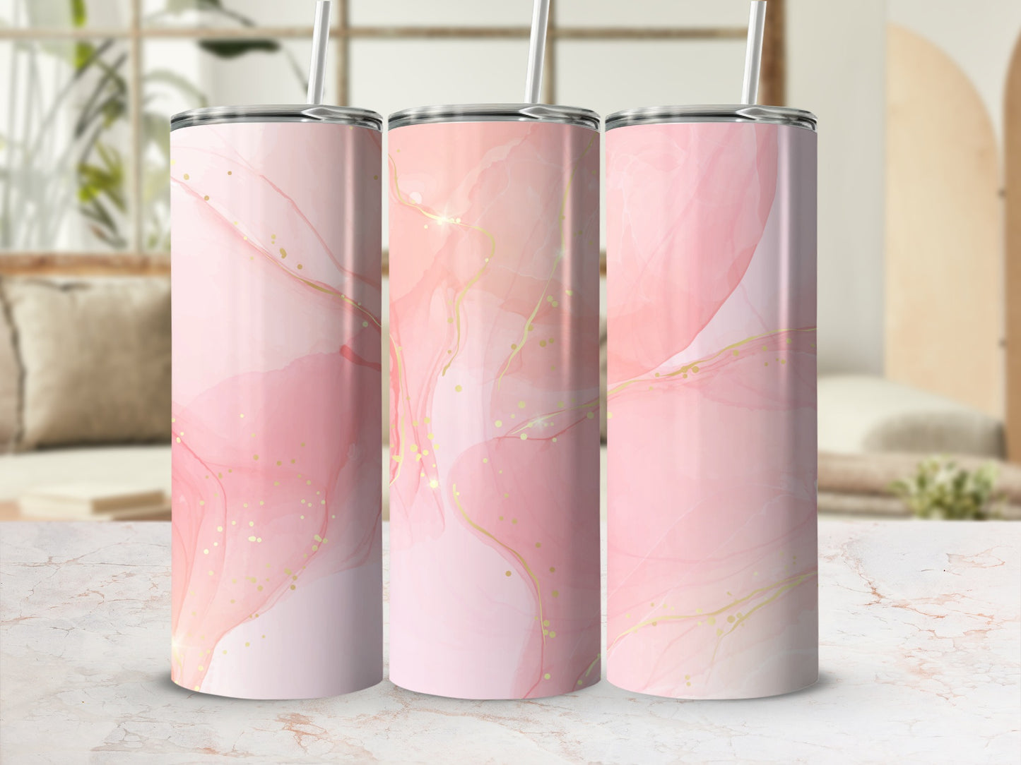 Pink and gold marbled pattern on three tumblers with straws.