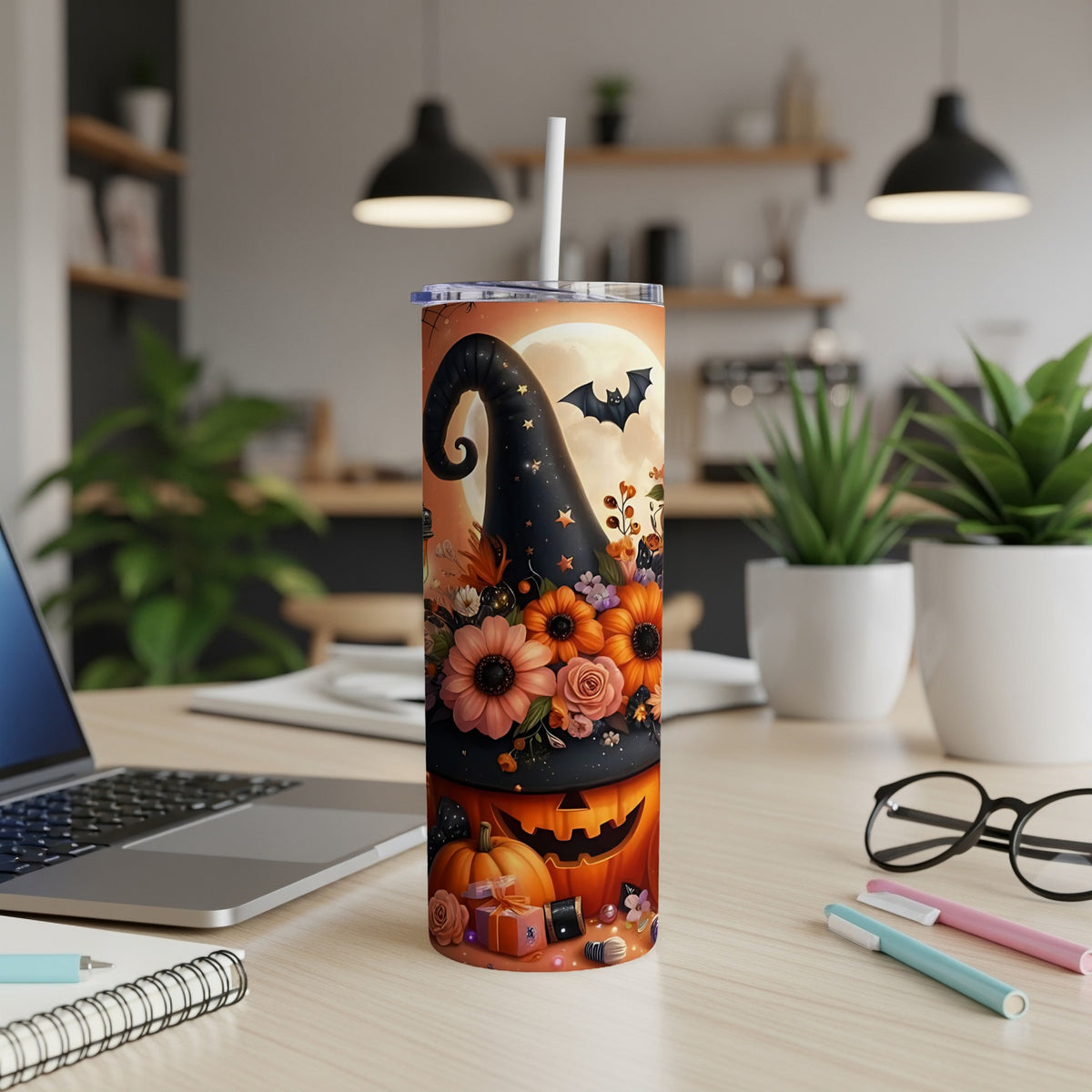 Halloween tumbler with witch hat, pumpkin, flowers, and flying bat design.