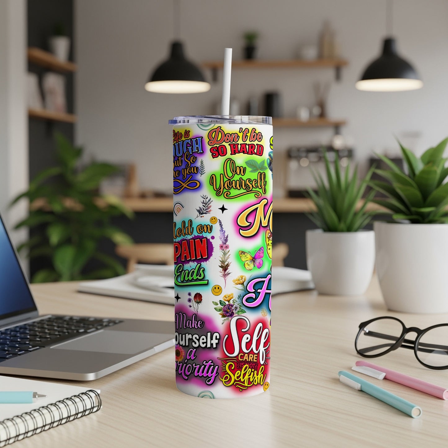 Tumbler with colorful text and butterfly graphics, including "Don't be too hard on yourself".