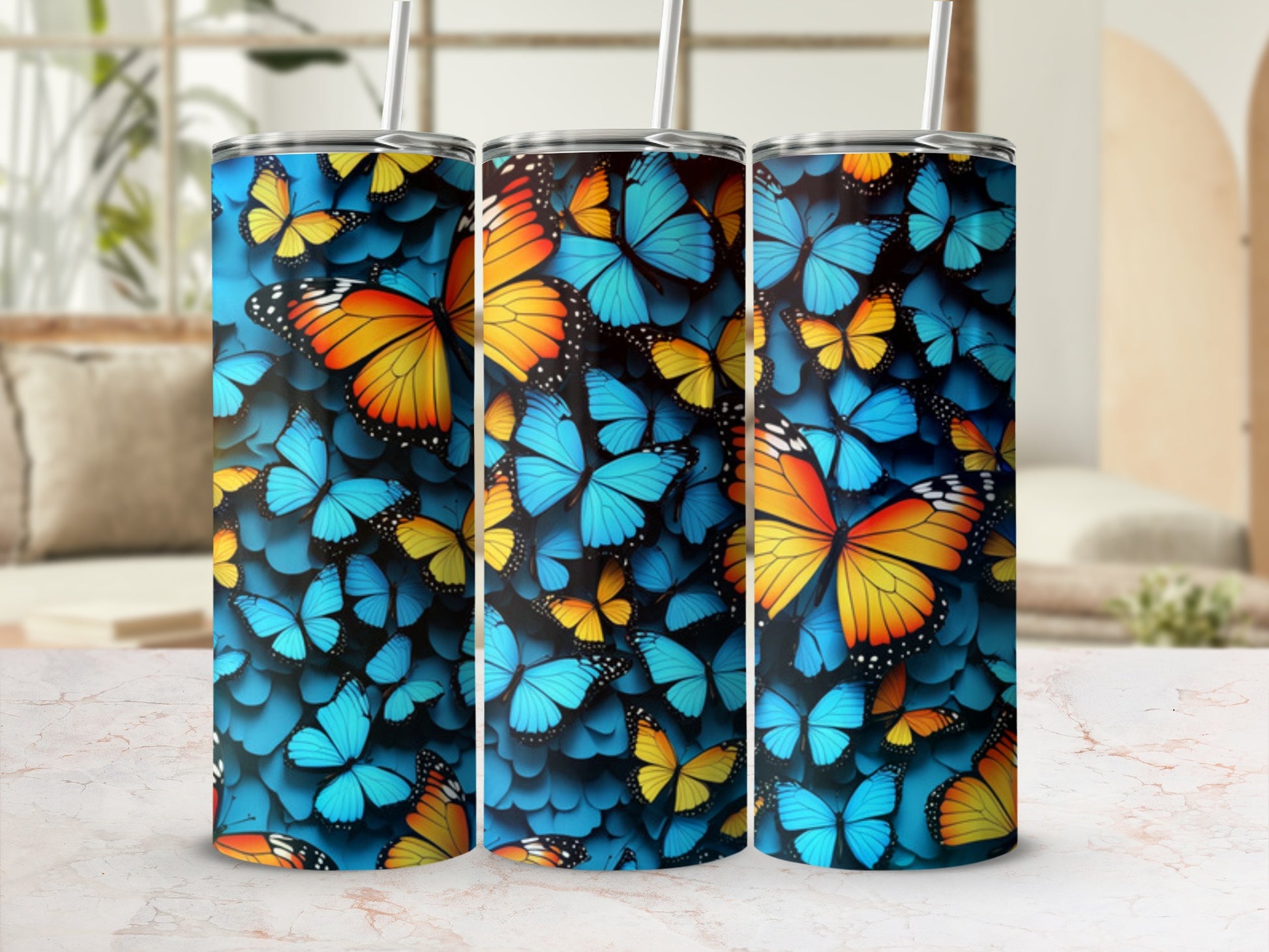 Three tumblers with a vibrant blue and yellow butterfly pattern.