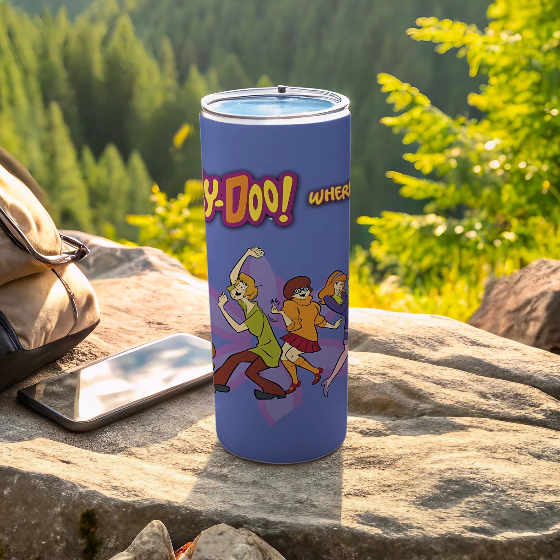 Scooby-Doo! Where! text on a purple tumbler with characters in a forest setting.