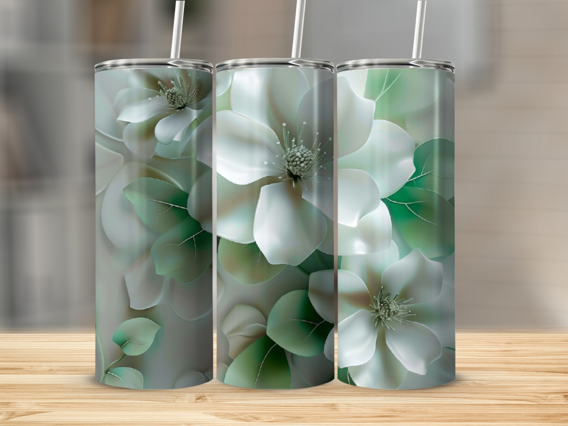 Three tumblers with white magnolia flowers and green leaves design.