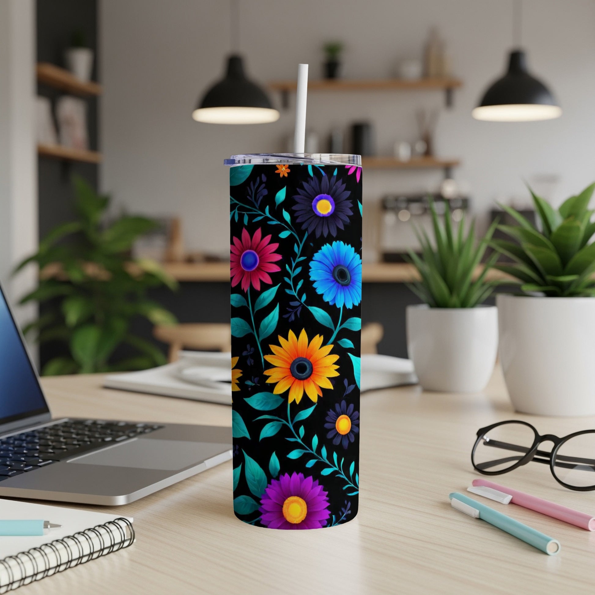 Black tumbler with colorful floral pattern and white straw.