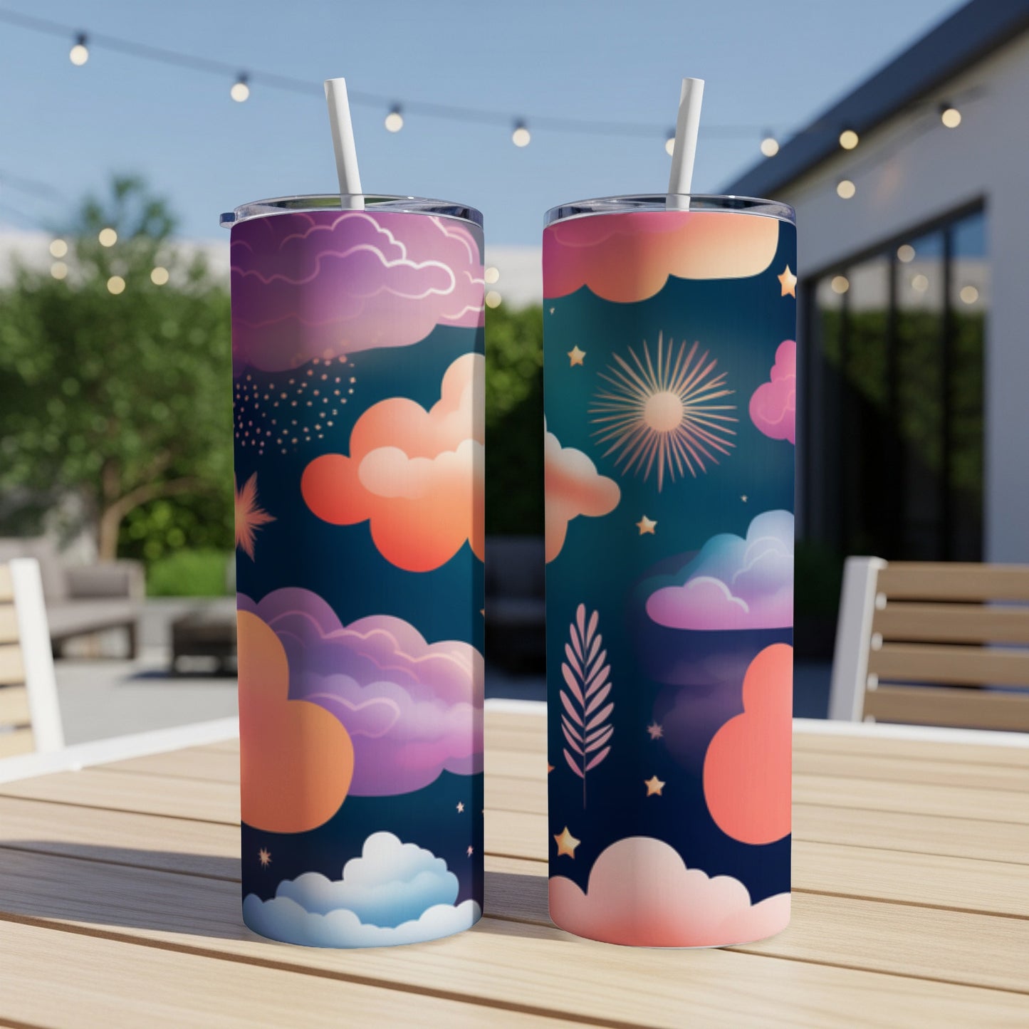 Two tumblers with a starry night and cloud design, on a table.