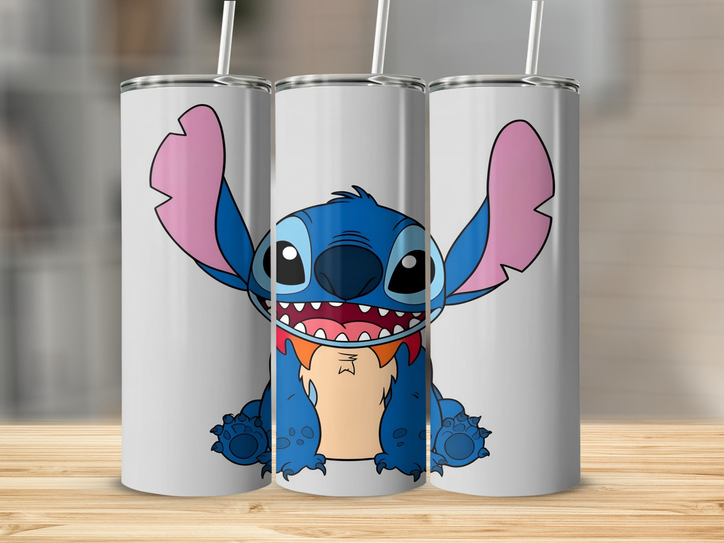 Blue Stitch character with open mouth and large ears on three white tumblers.