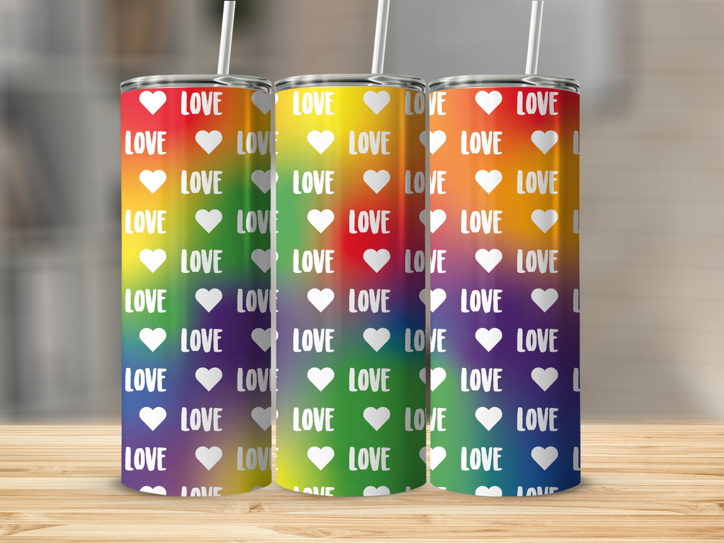Rainbow gradient tumbler with repeating "LOVE" and heart pattern.