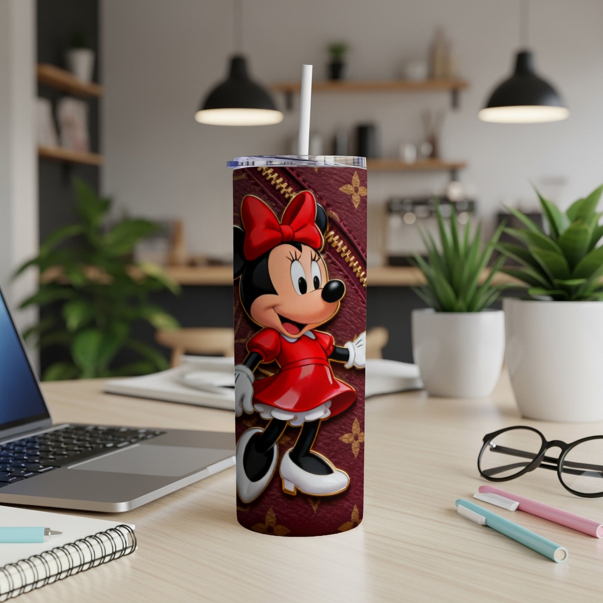 Minnie Mouse on a burgundy patterned tumbler with a white straw.