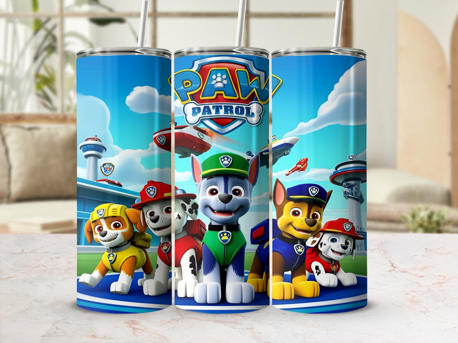 Paw Patrol characters Chase, Marshall, Rubble, and Skye on a blue tumbler.