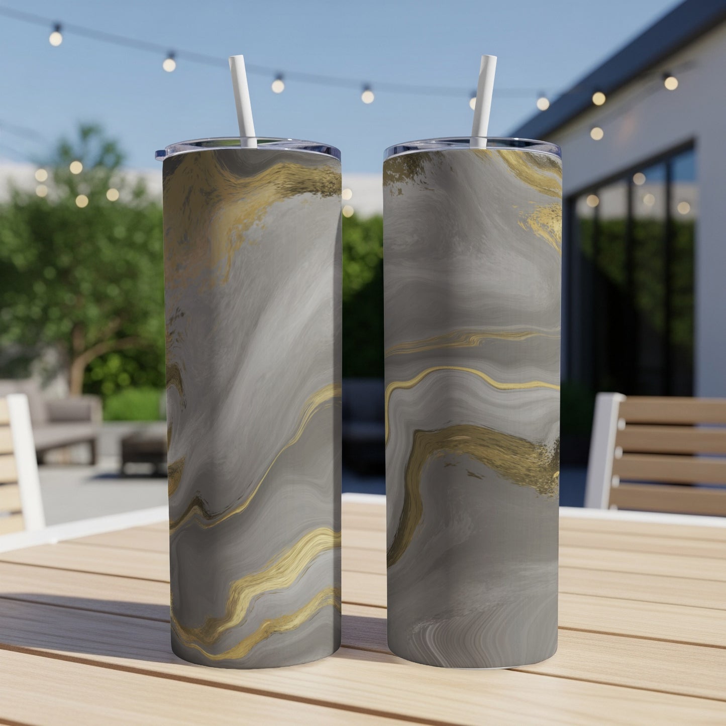 Two tall tumblers with gray and gold marble pattern on a table.