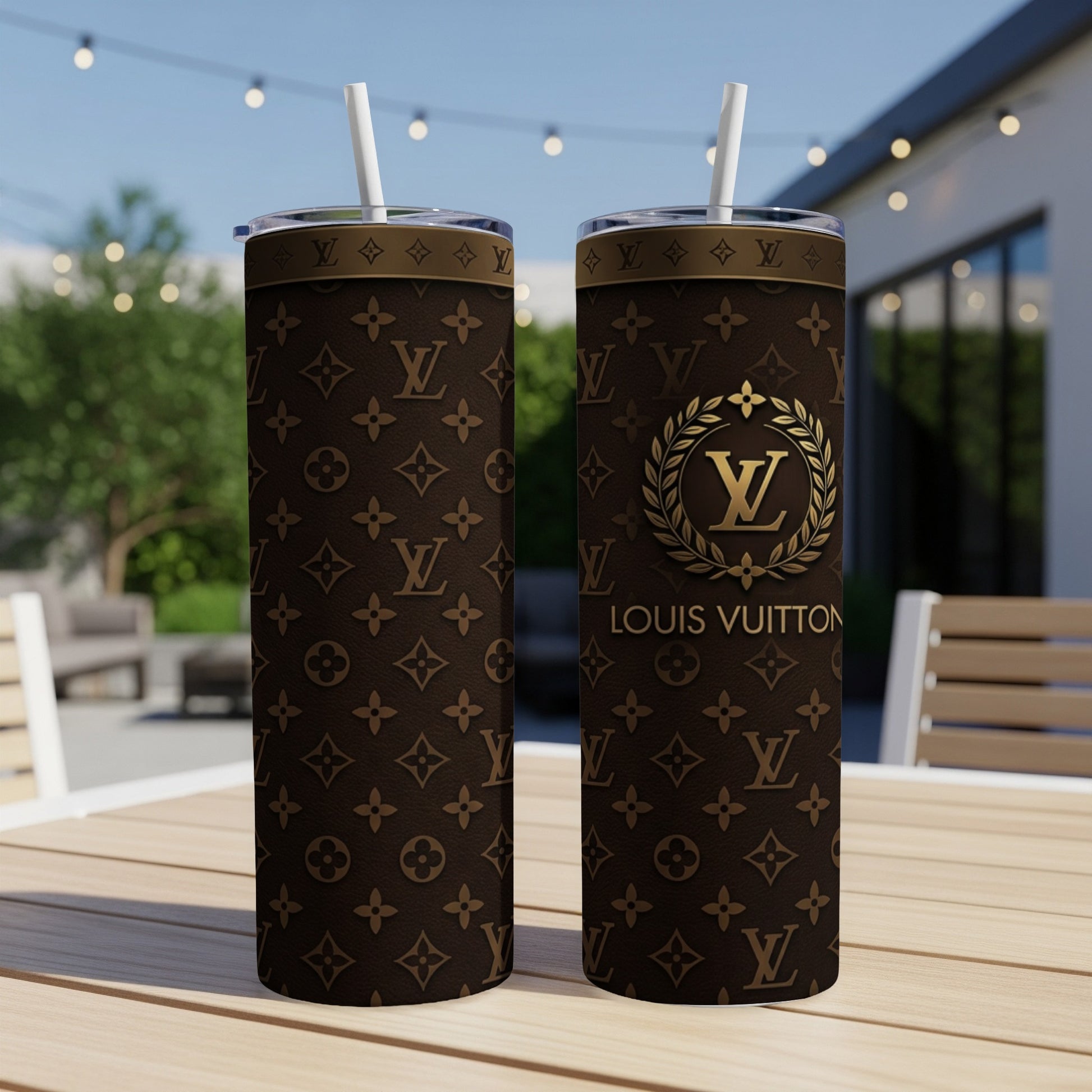 Two Louis Vuitton tumblers on a table, featuring the monogram pattern.