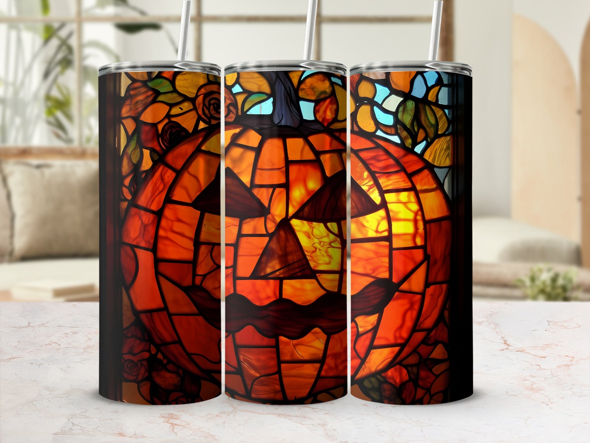Stained glass pumpkin tumbler with straw in front of blurred window.