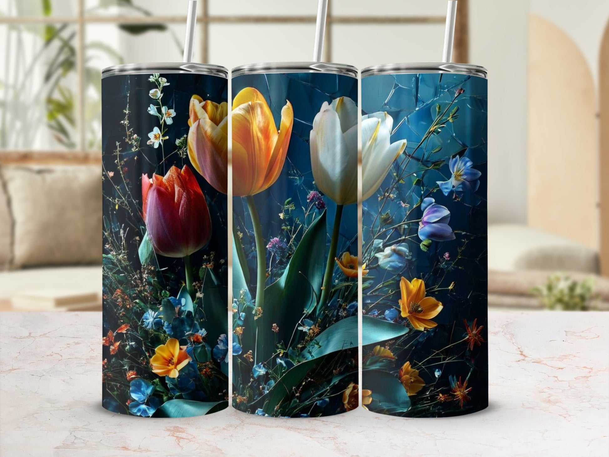 Three tumblers with vibrant floral art, featuring tulips and other blooms.
