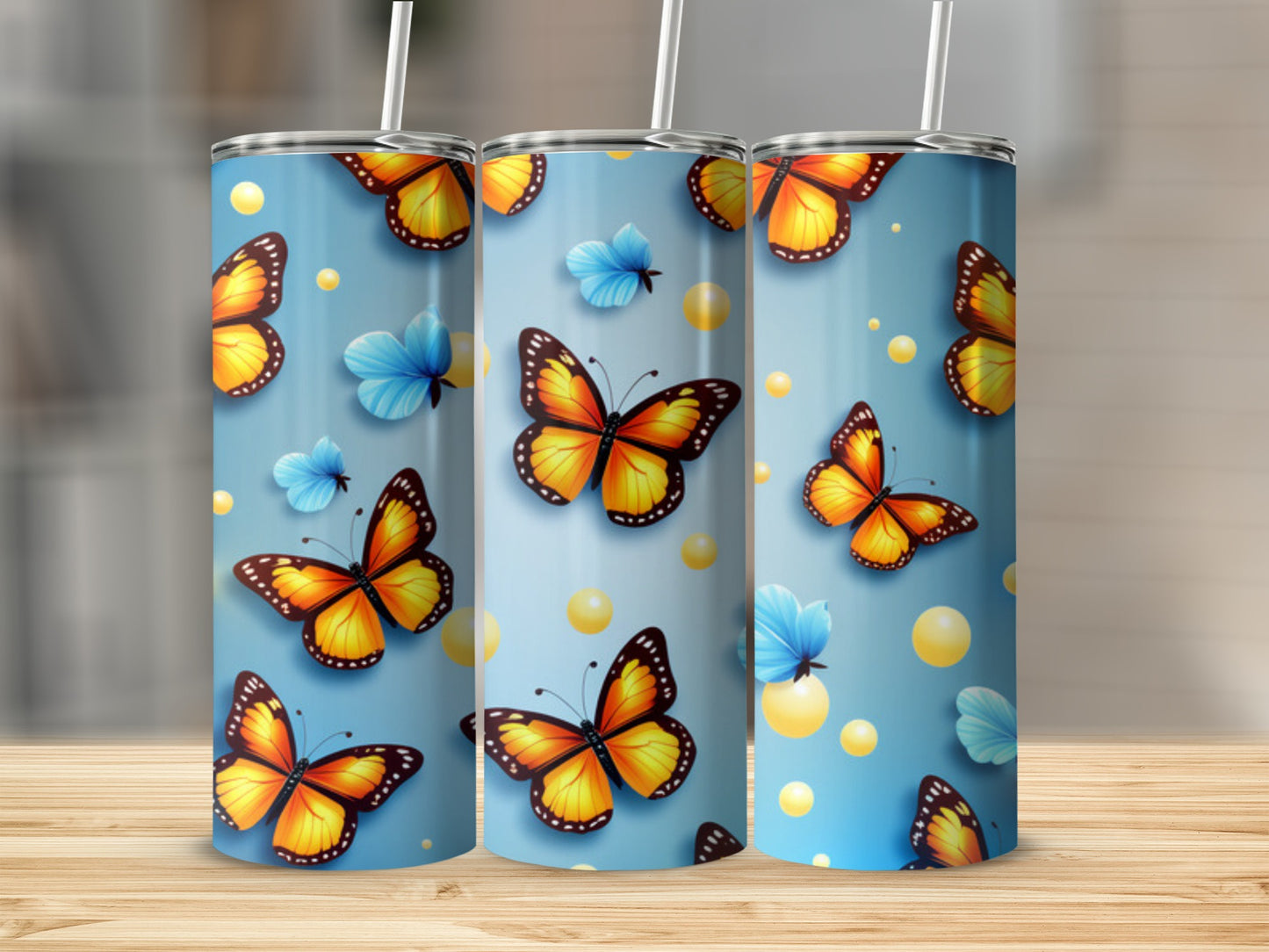 Three tumblers with orange butterflies and blue butterflies on a blue background.