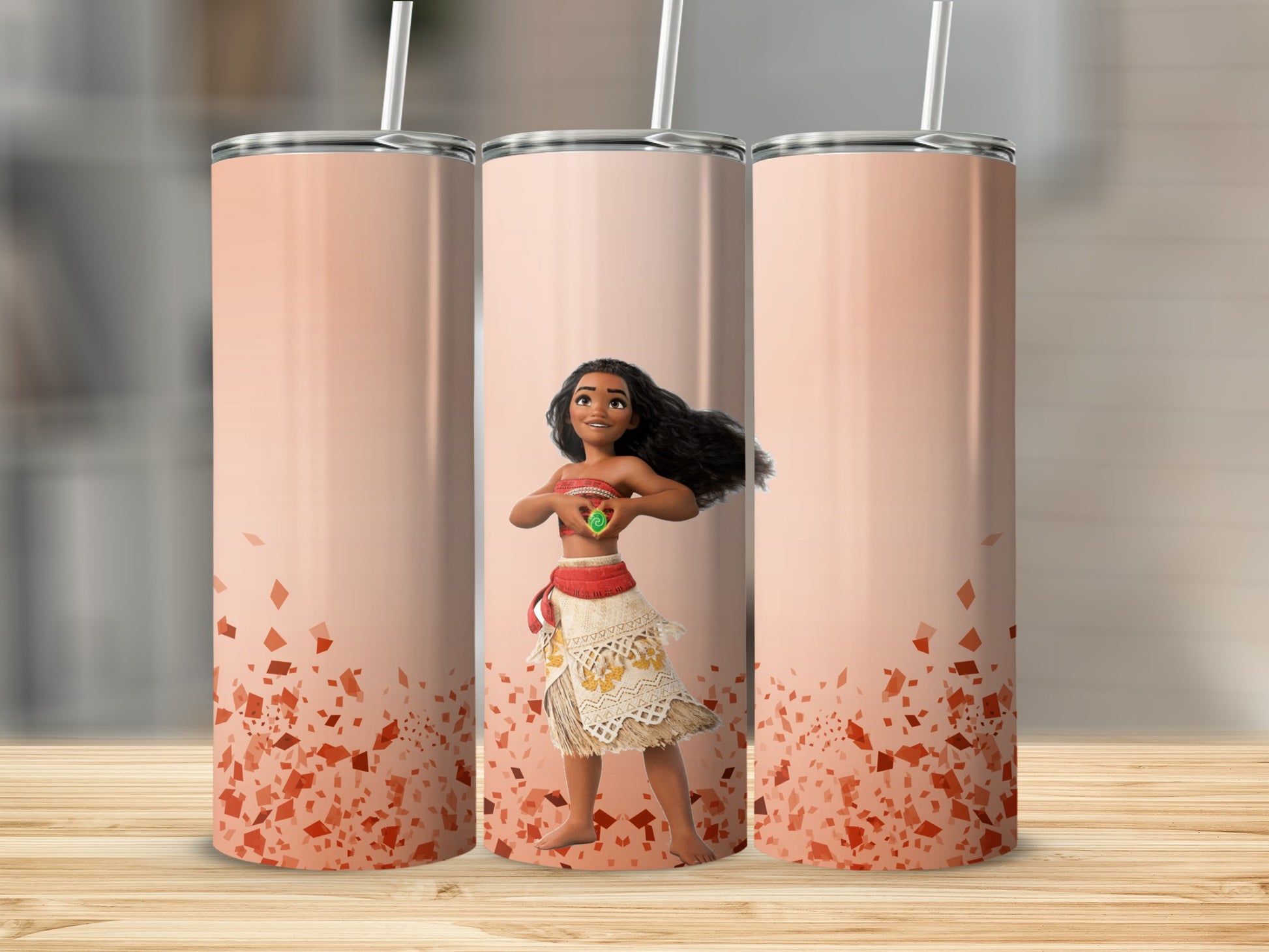 Moana with a heart shape on a gradient tumbler with orange confetti.