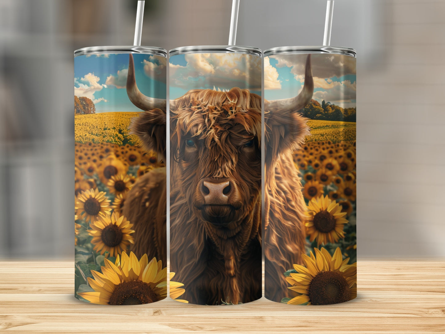 Highland cow in sunflower field, artwork on three tumblers.
