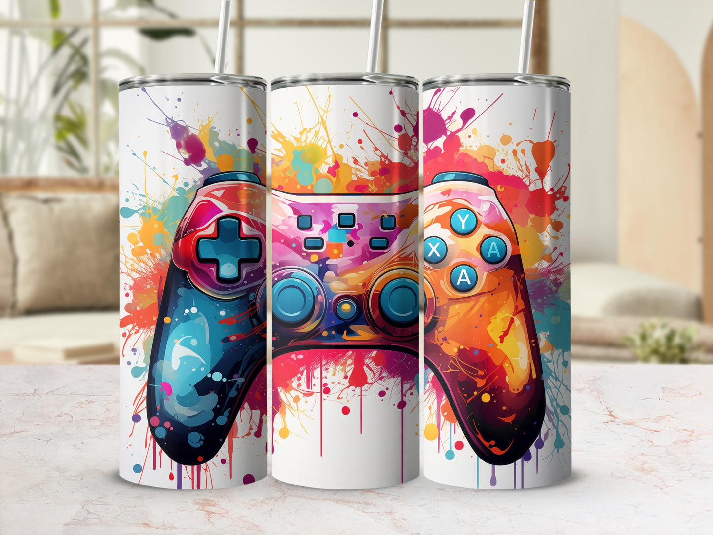 Three tumblers with colorful video game controller splatter art.