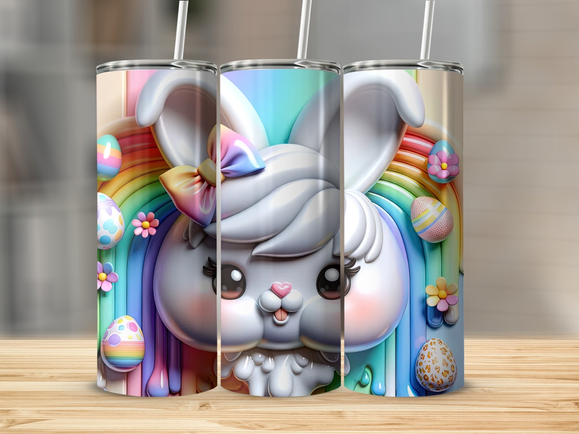 Three Easter bunny tumblers with rainbows and decorated eggs.
