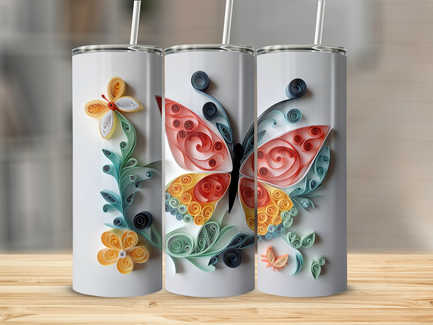 Three tumblers decorated with colorful quilled butterflies and flowers.