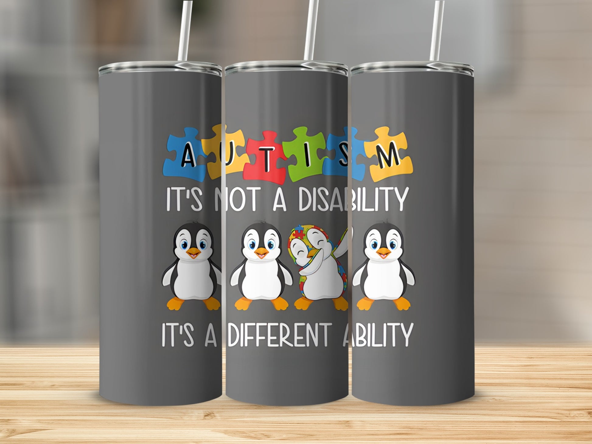 Autism awareness tumbler with penguins and puzzle pieces.