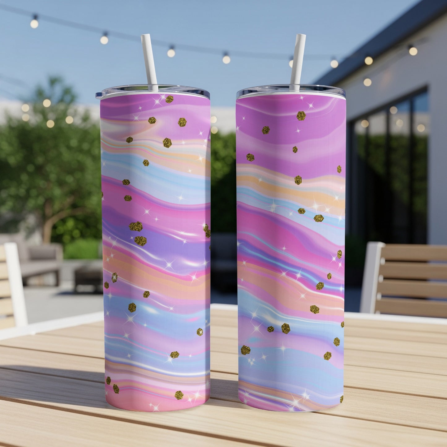 Two tumblers with a pastel marble pattern and gold glitter accents on a wooden table.