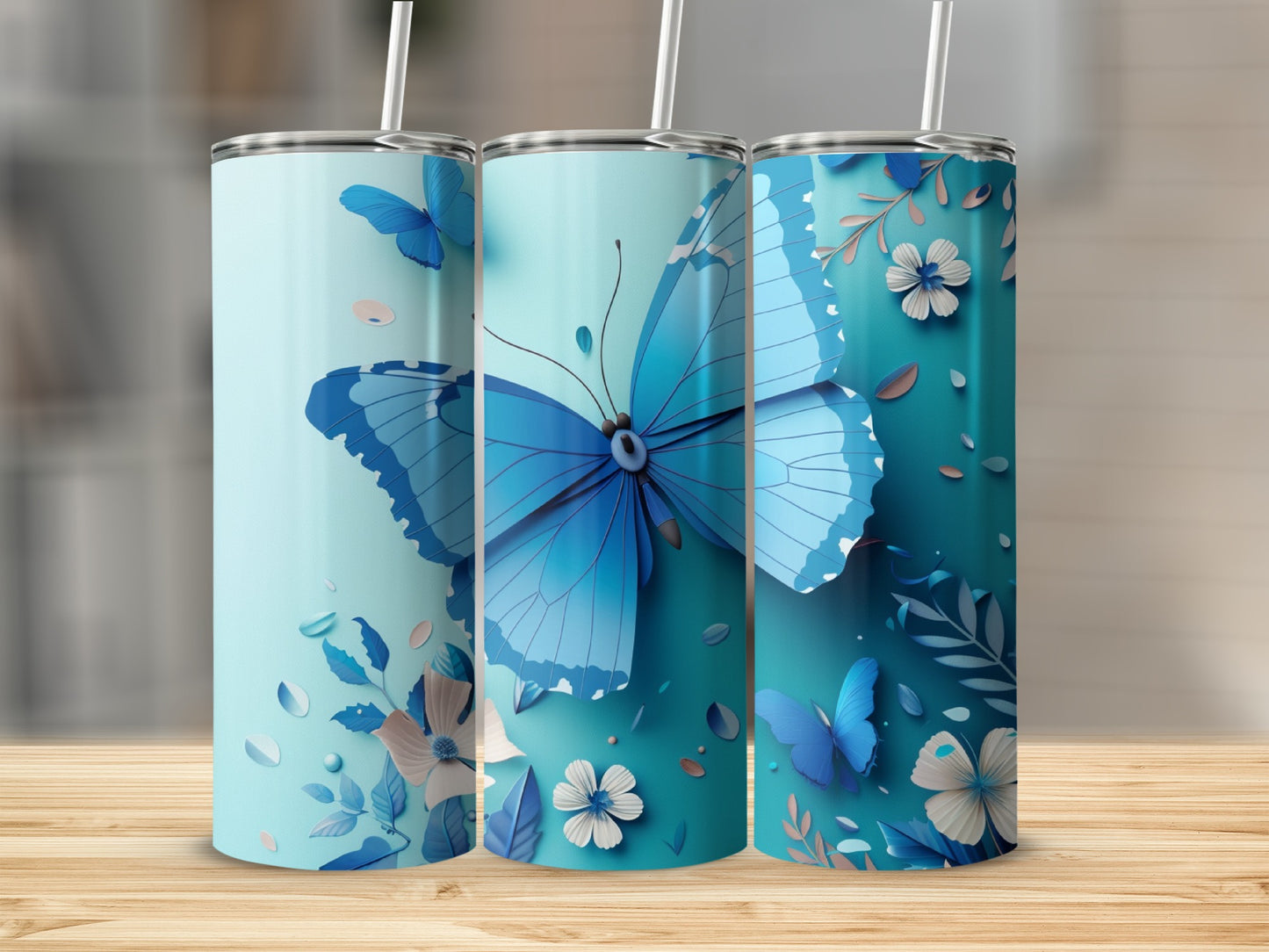 Three blue tumblers featuring delicate butterfly and floral designs.