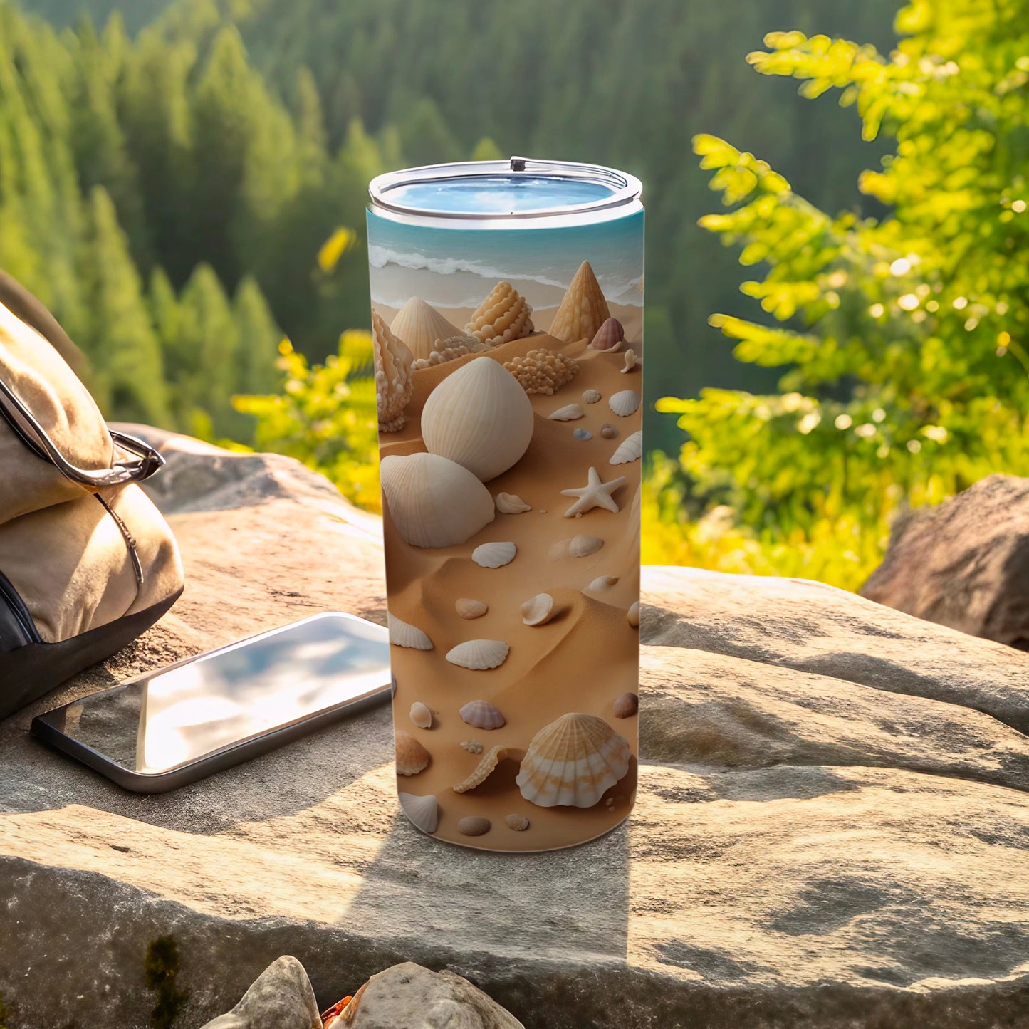 Seashells and sand design on a tall, slim tumbler with a backpack and phone.
