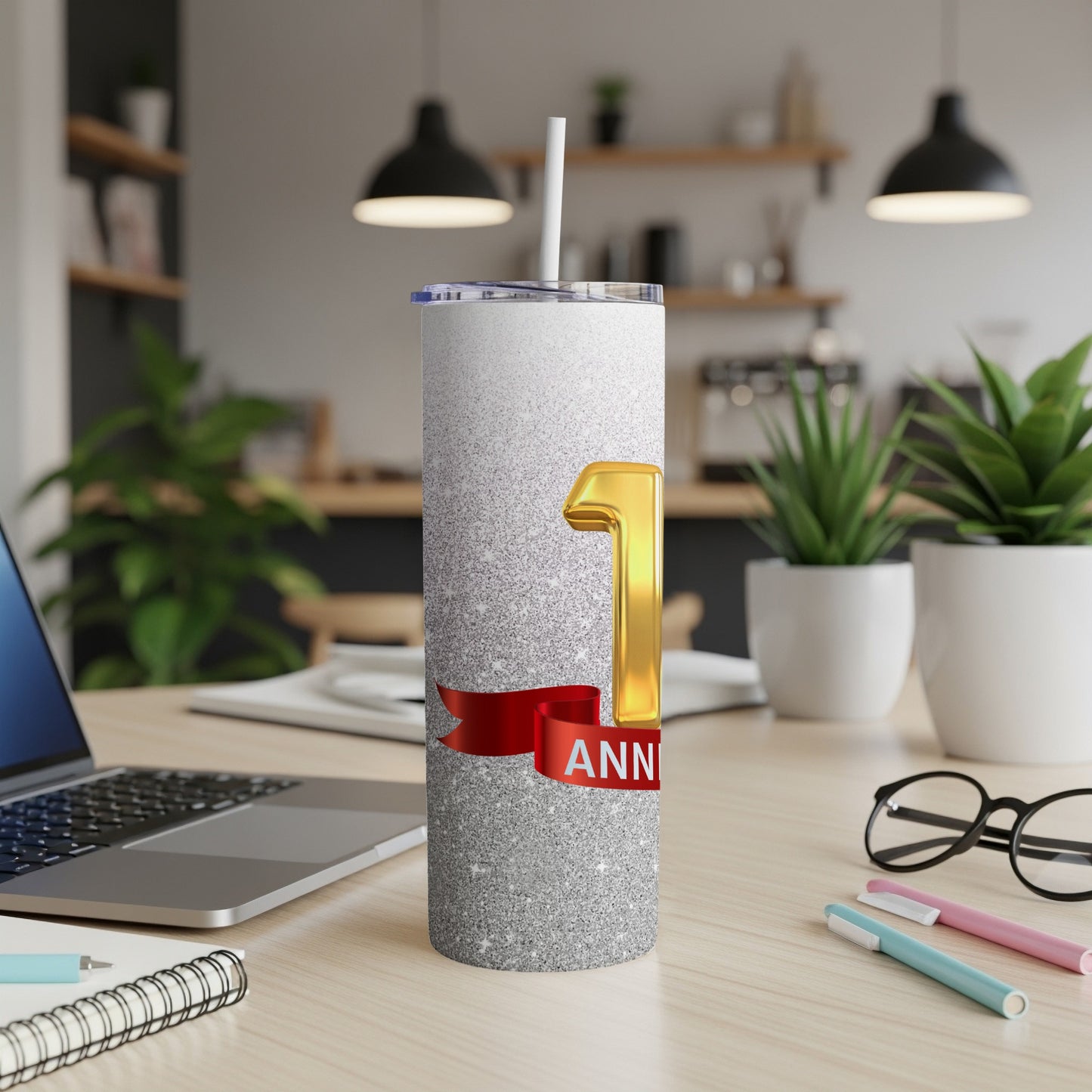 Silver glitter tumbler with "1st ANNIVERSARY" text and red ribbon.