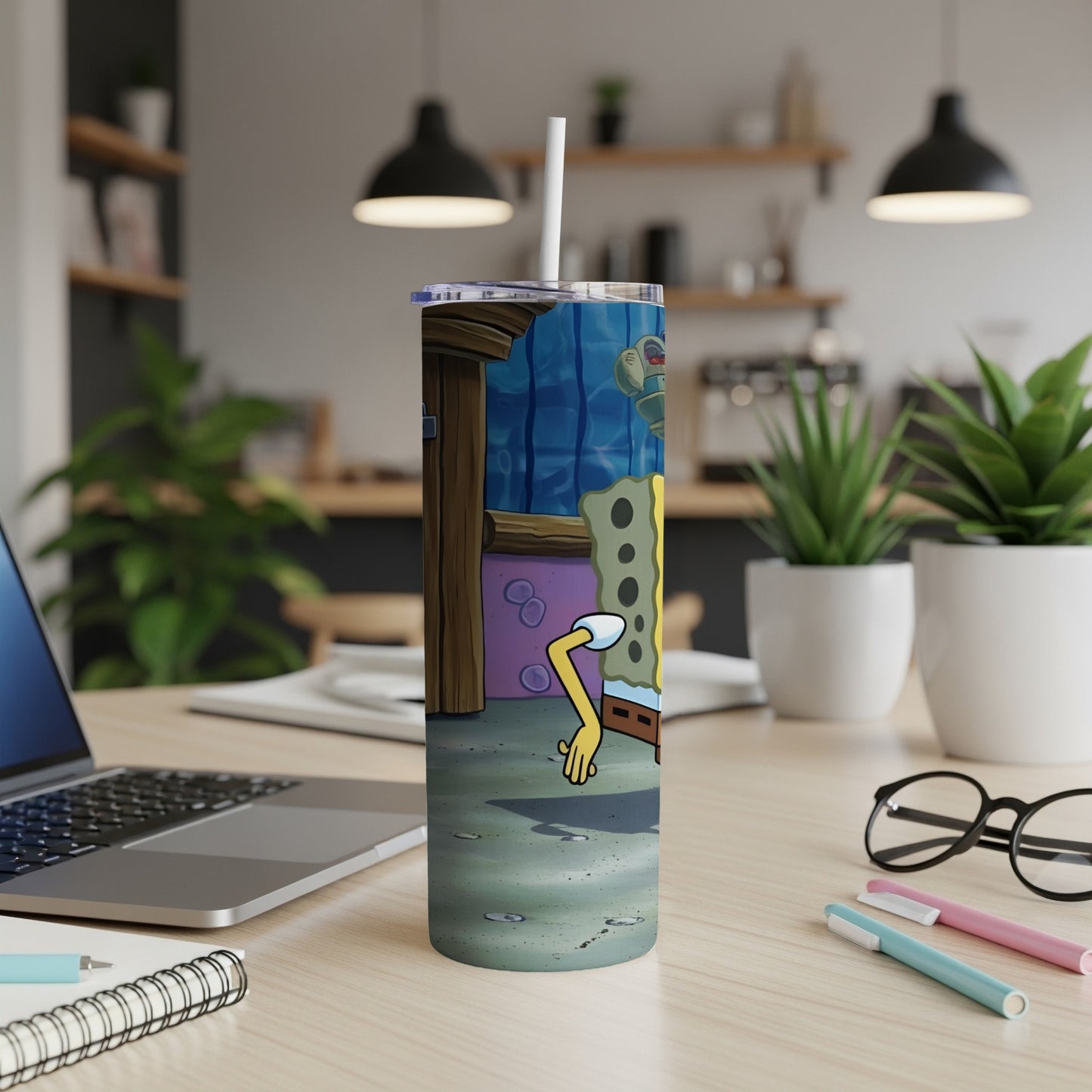 SpongeBob SquarePants character on a tumbler with a straw in a kitchen setting.