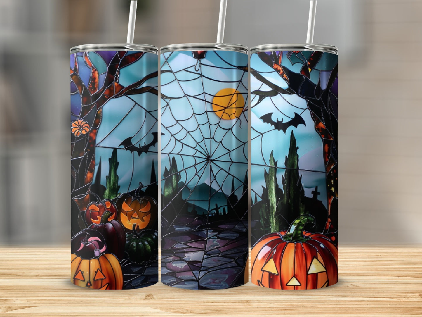 Three tumblers featuring stained glass Halloween scenes with pumpkins and bats.