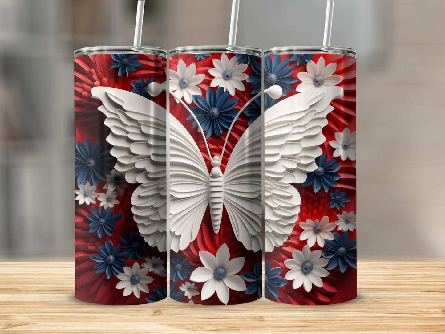 Three tumblers with white butterfly and floral designs on red background.