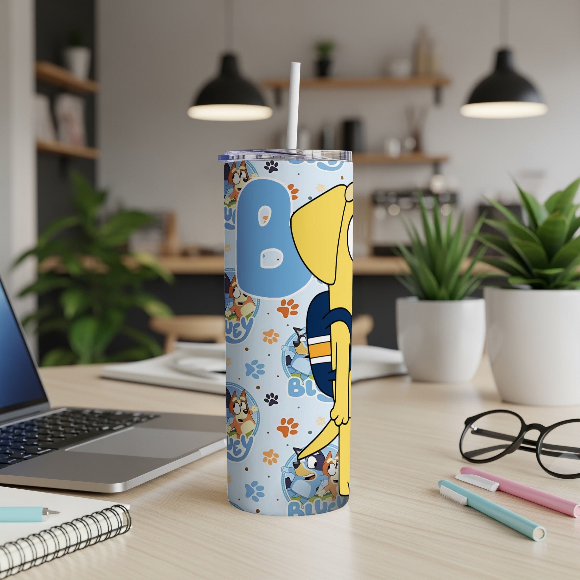 Bluey character design on a light blue, patterned tumbler with a straw.