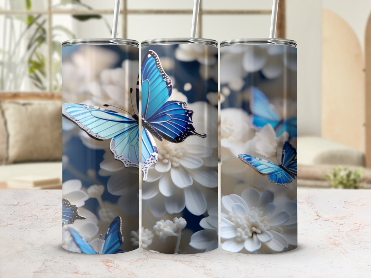 Three tumblers with blue butterflies and white flowers.