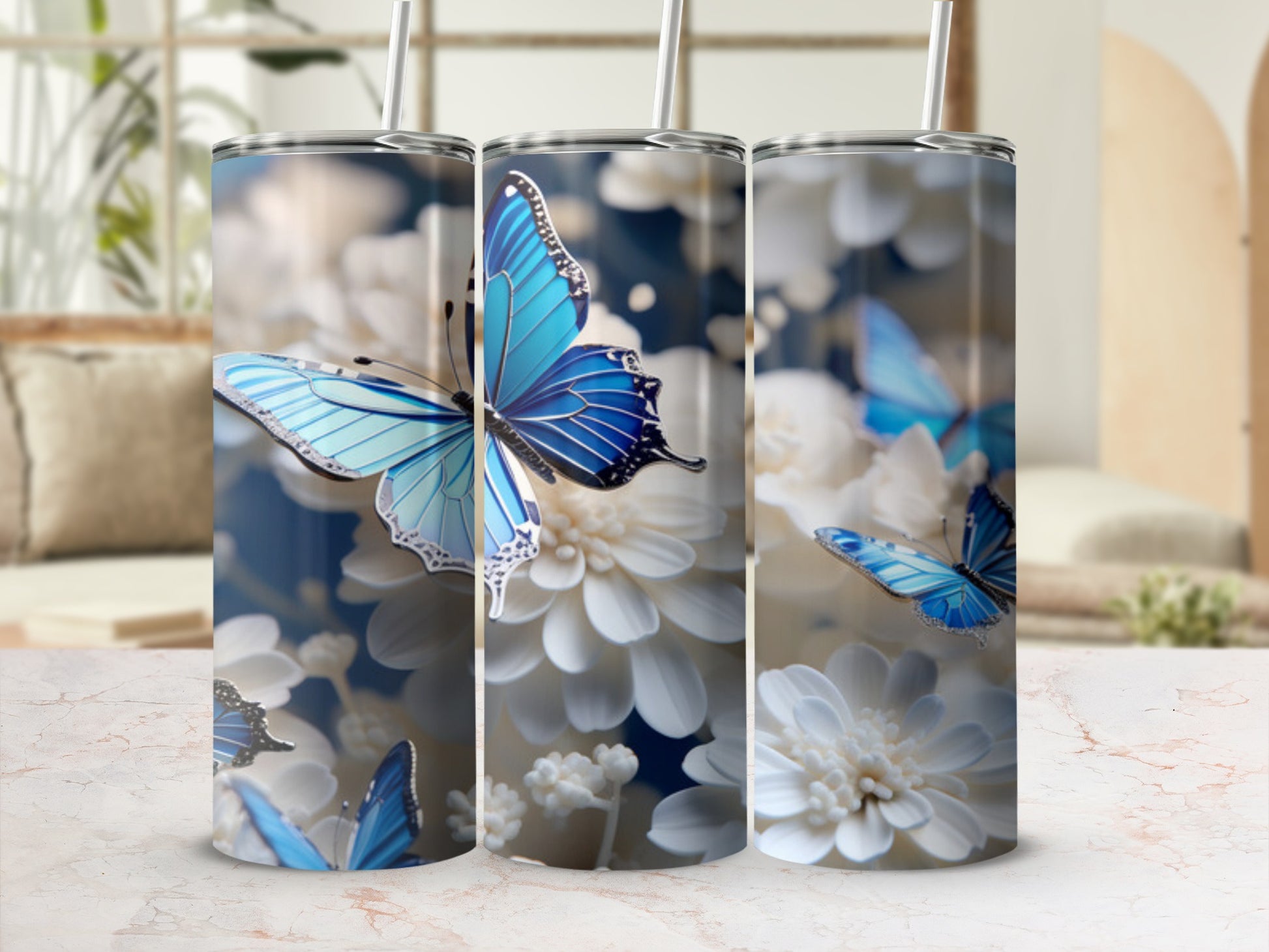 Three tumblers with blue butterflies and white flowers.