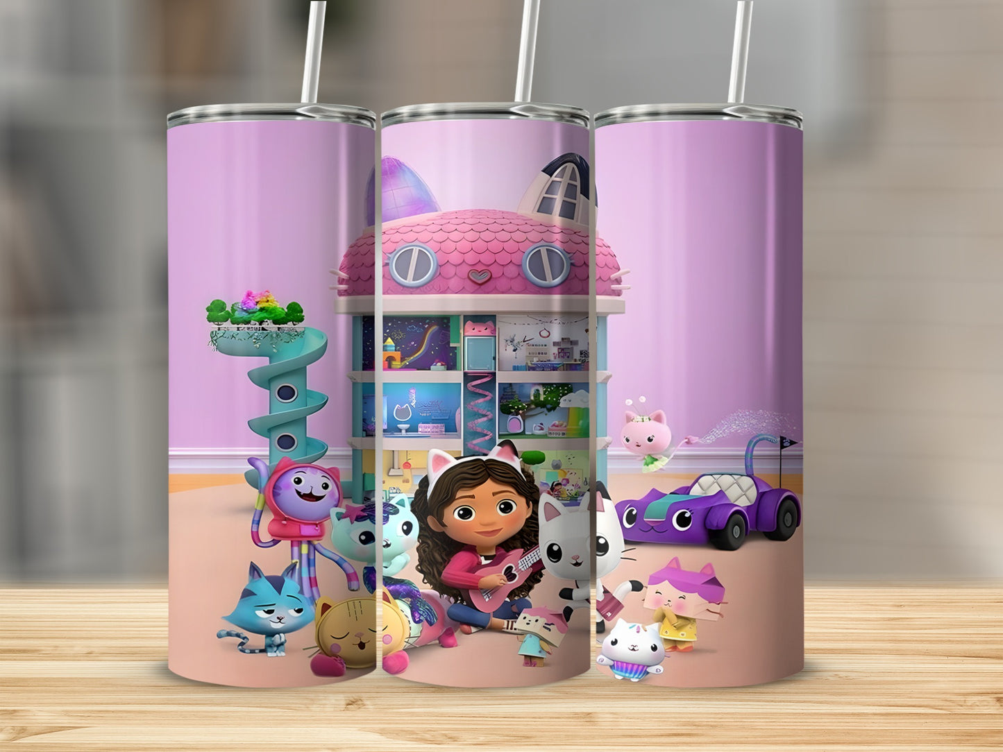 Gabby's Dollhouse characters and castle on a pink and purple tumbler.