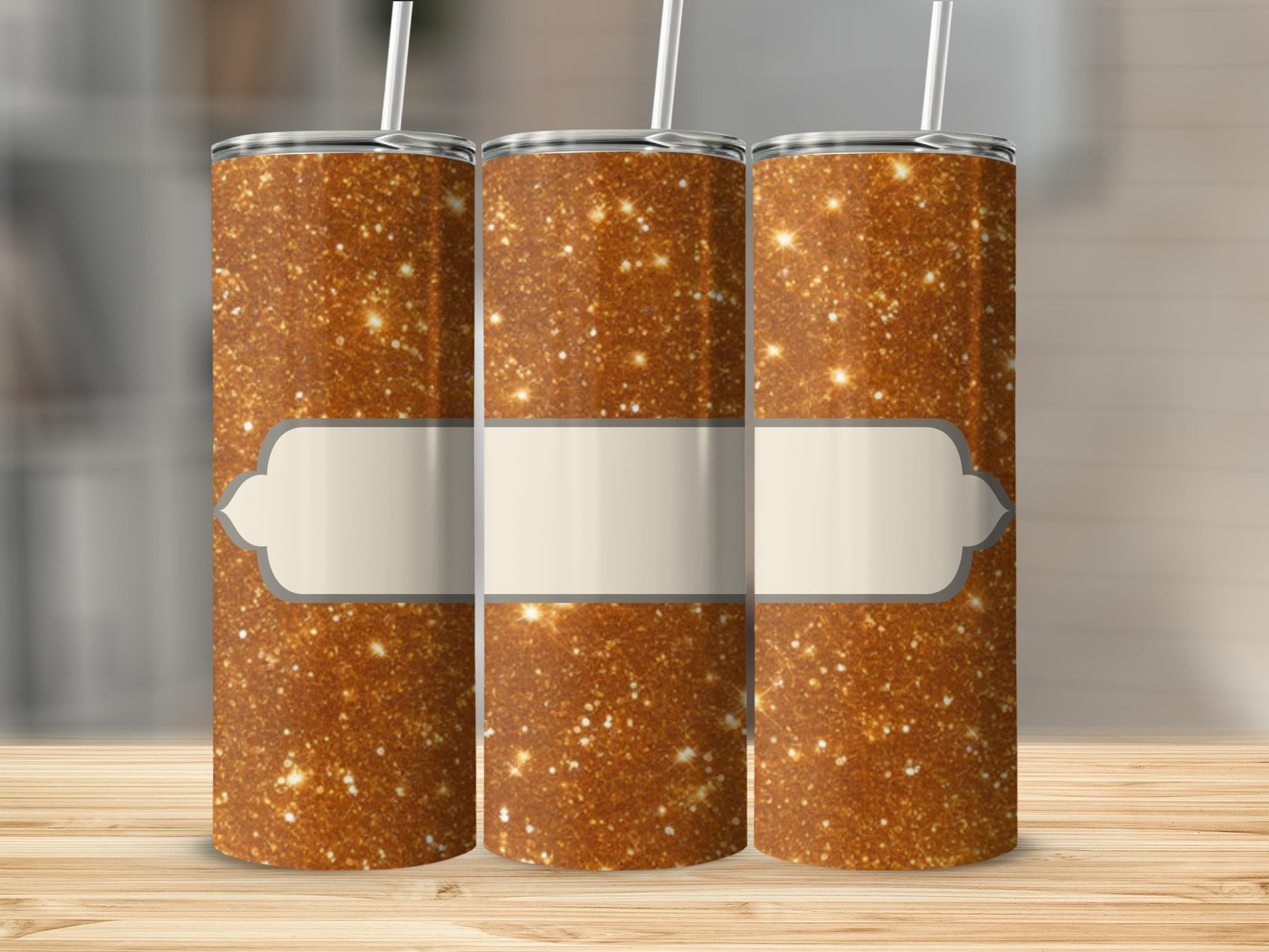 Three glitter tumblers with blank beige labels on a wooden surface.