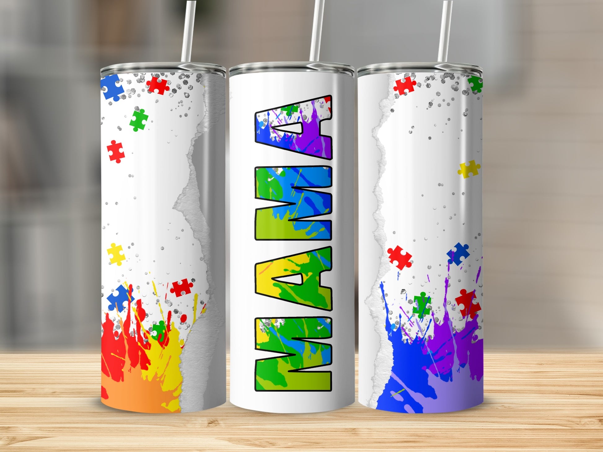 Mama tumbler with autism puzzle piece design and colorful paint splatters.