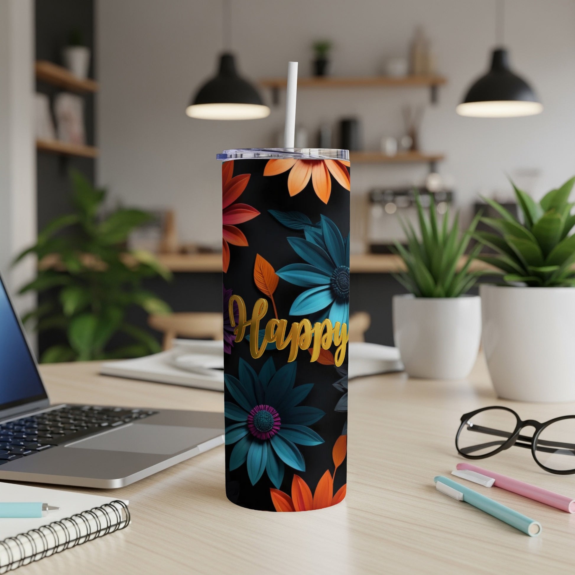 Black tumbler with floral pattern and "Happy" text, on a desk.