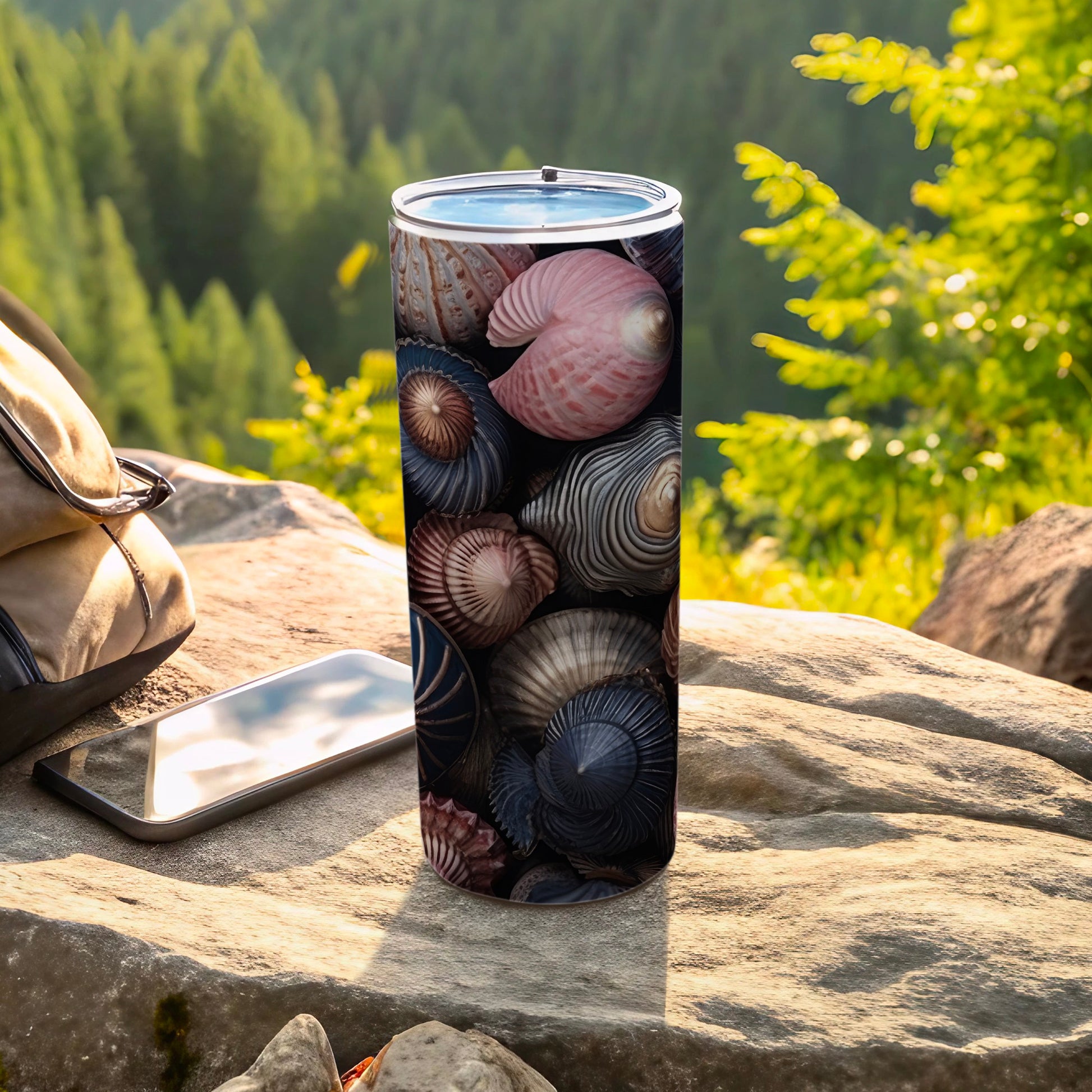 Tumbler with a detailed pattern of colorful seashells and a smartphone.