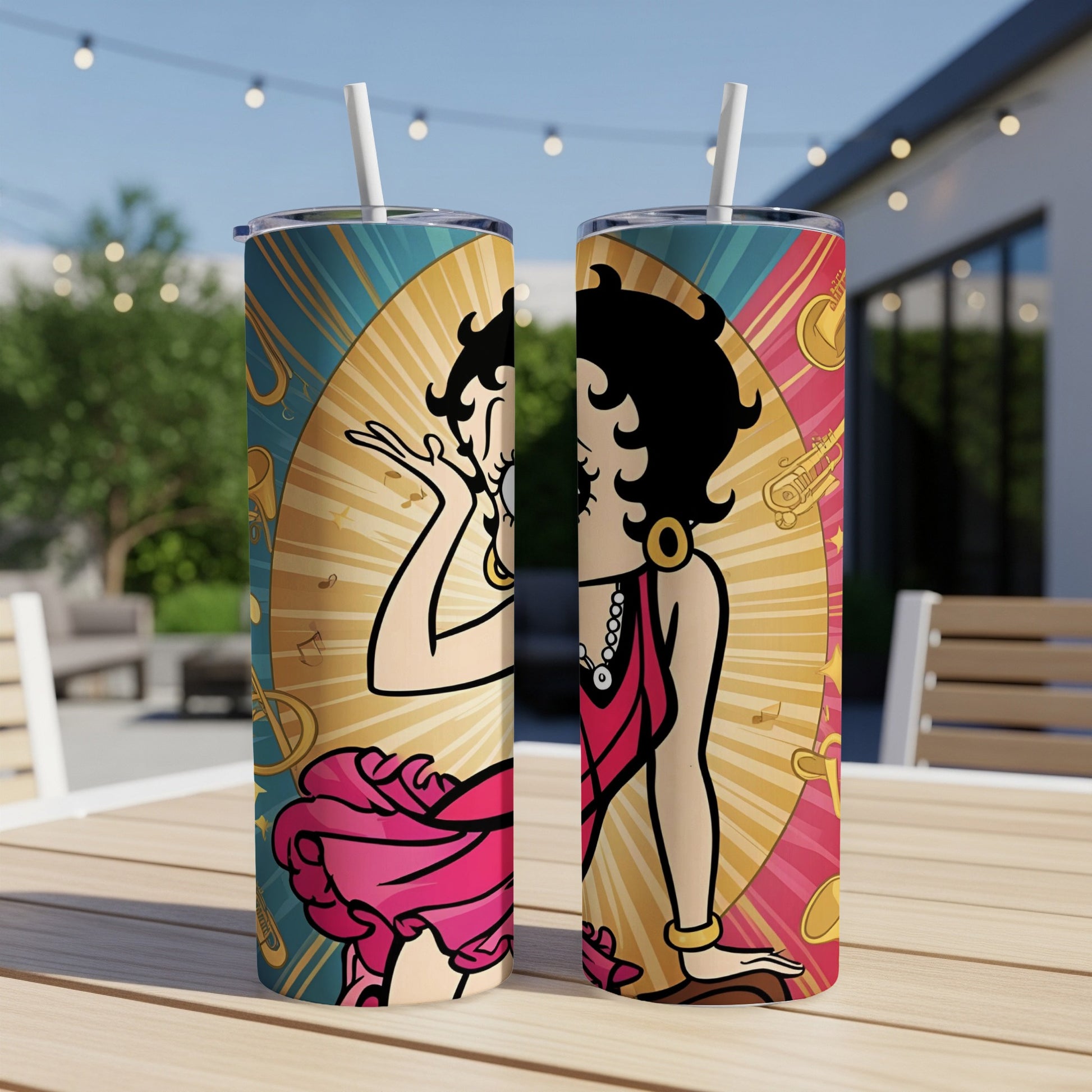 Two Betty Boop tumblers with musical notes and brass instruments on a table.