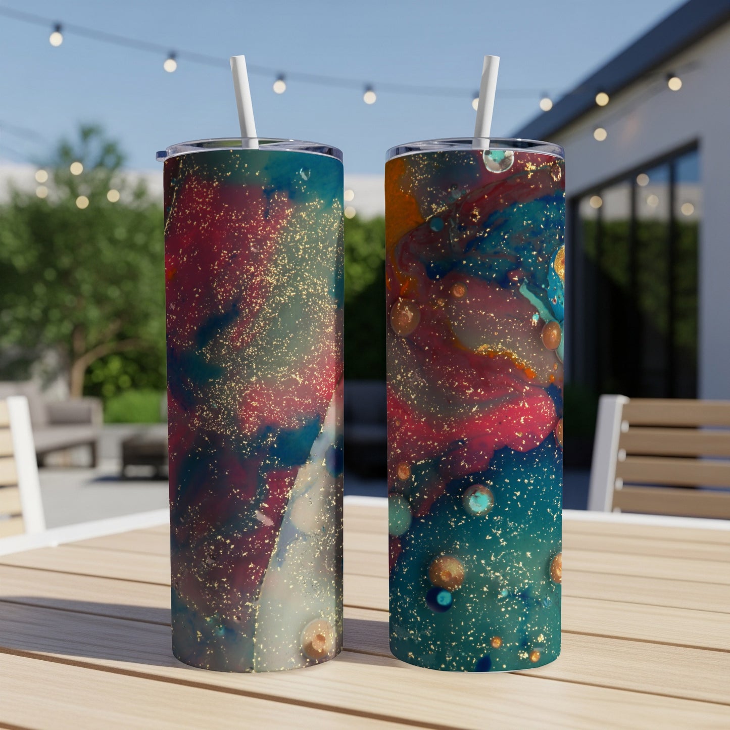 Two tall, skinny tumblers with a cosmic, colorful marbled design and gold flecks.
