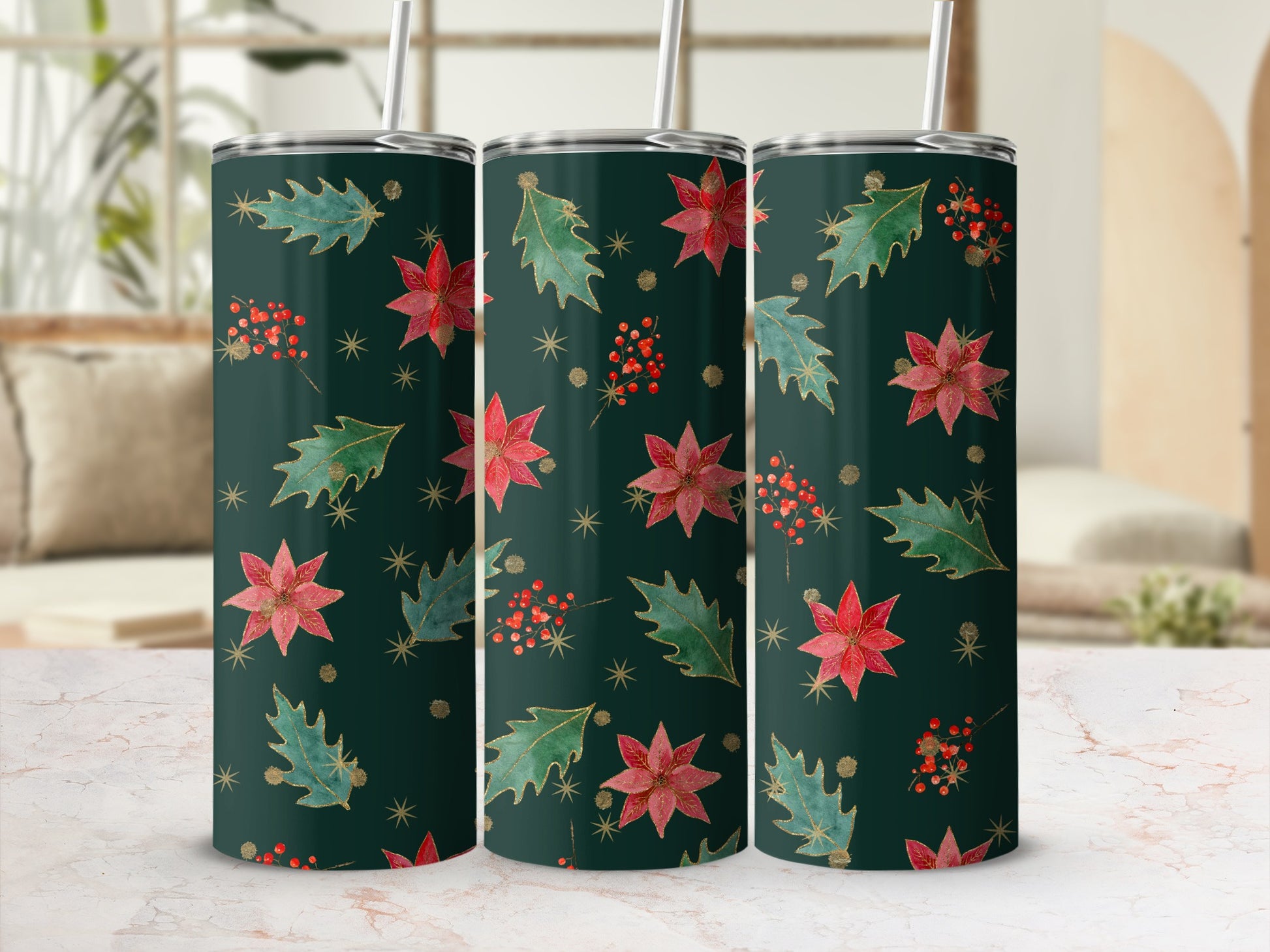 Green tumblers with poinsettias and holly pattern, displayed on marble.