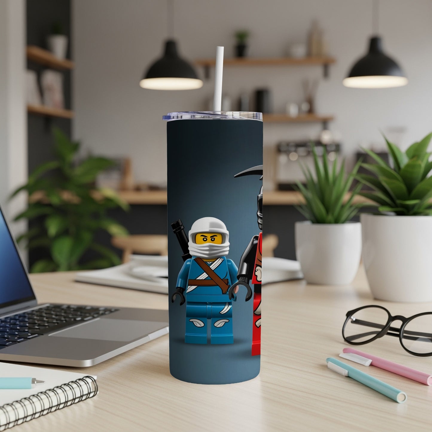 Two Lego minifigures, one in blue and one in red, stand on a tumbler.