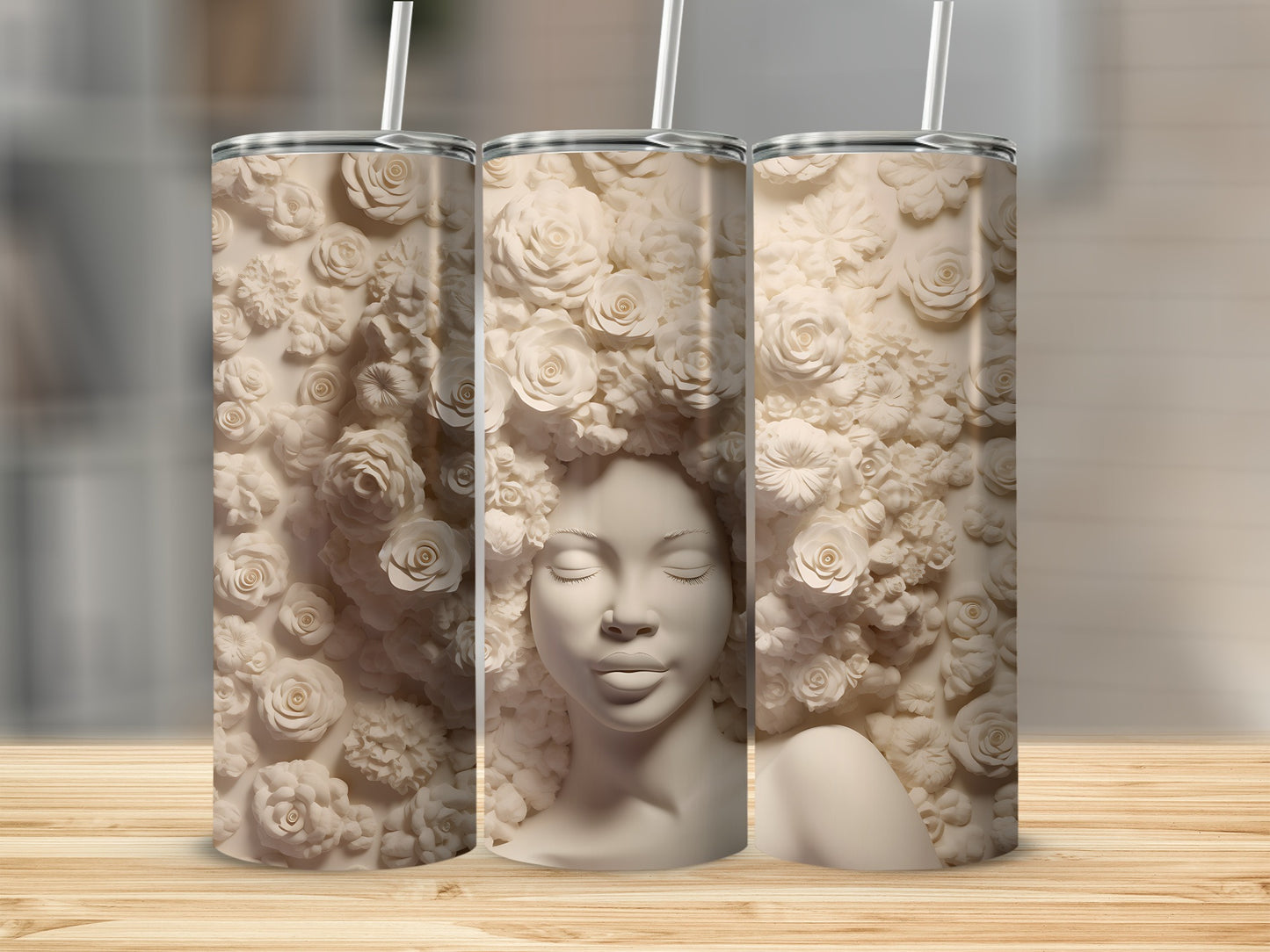 Three tumblers featuring a sculpted woman's face surrounded by floral relief.