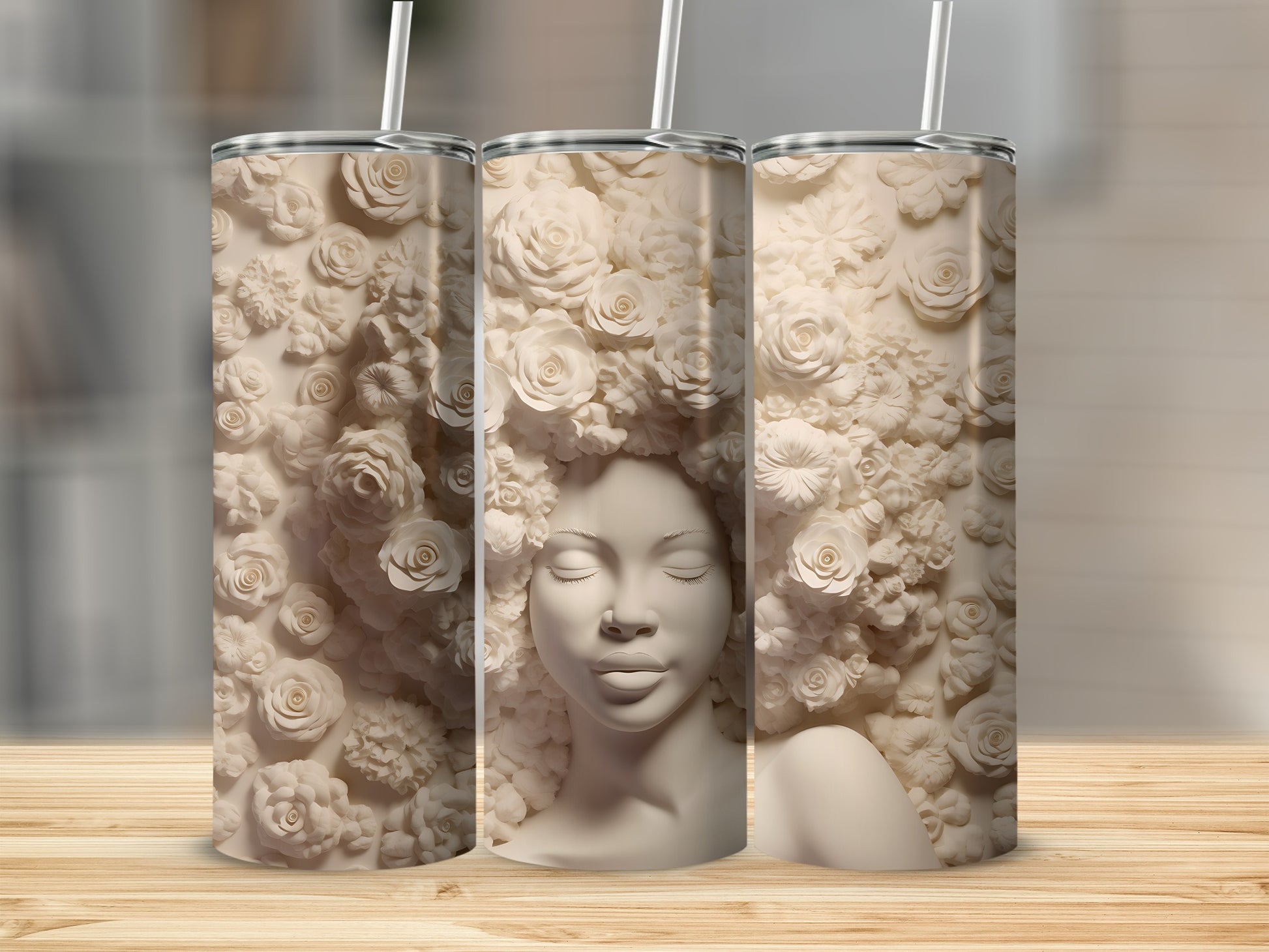 Three tumblers featuring a sculpted woman's face surrounded by floral relief.