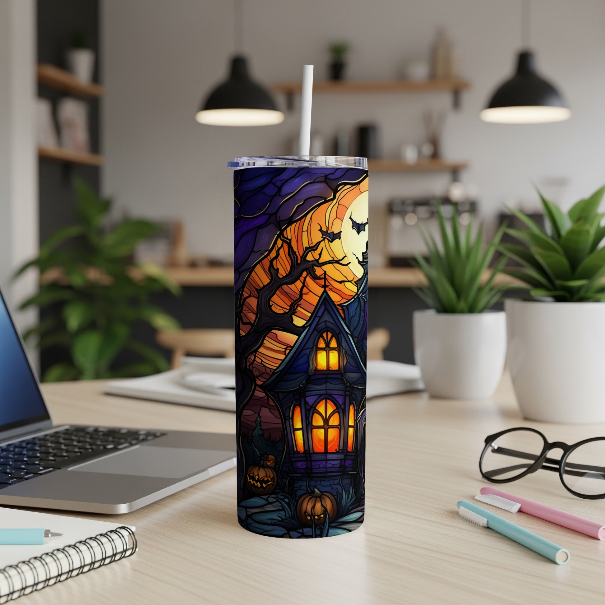 Stained glass tumbler with haunted house, moon, and pumpkins.