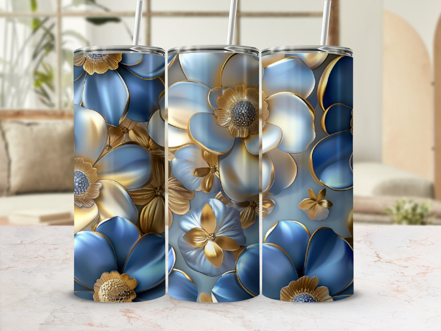 Three tall tumblers with a blue and gold floral pattern and straws.