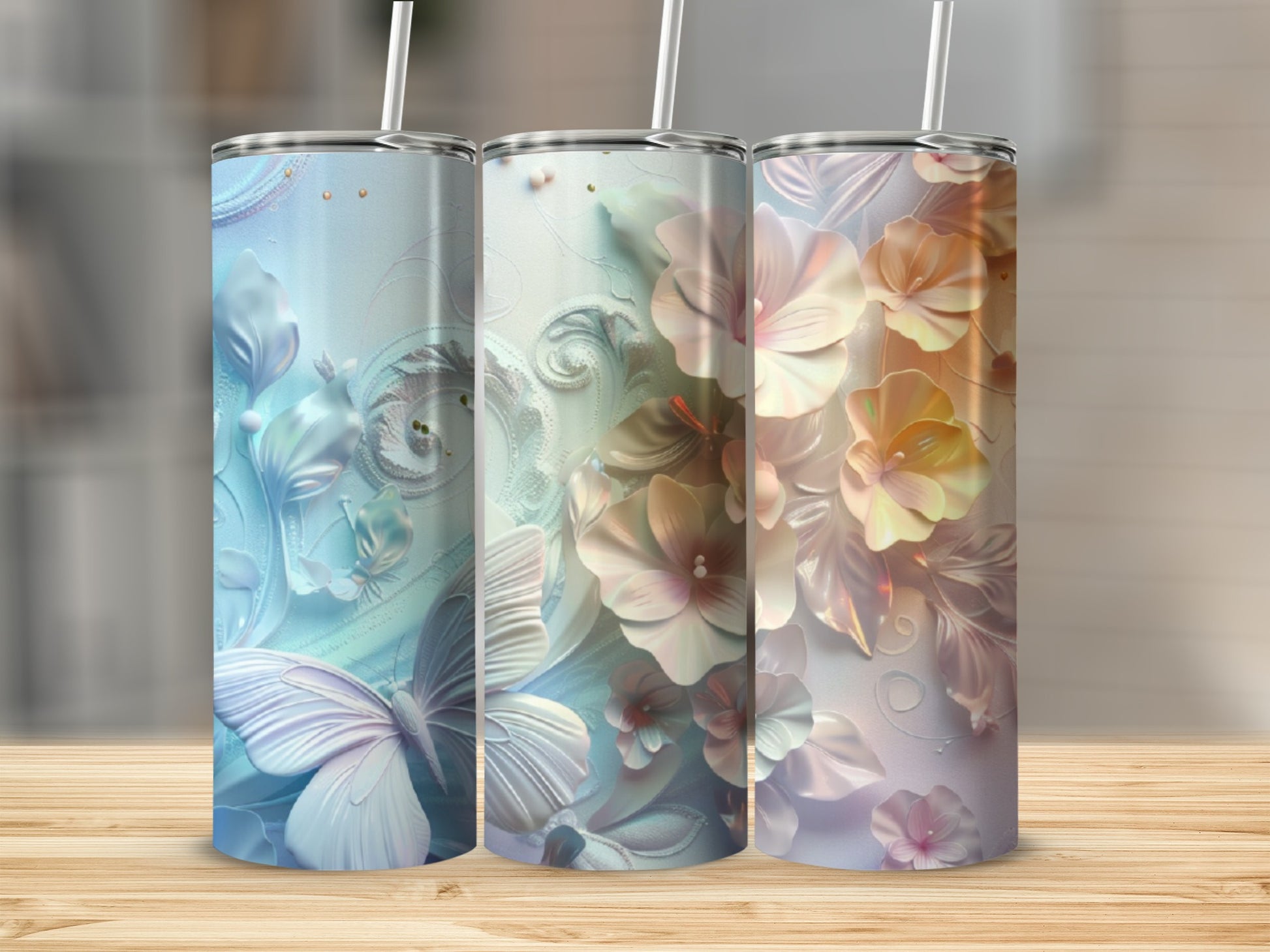 Three floral tumblers with butterflies and intricate patterns in blue, white, and peach.