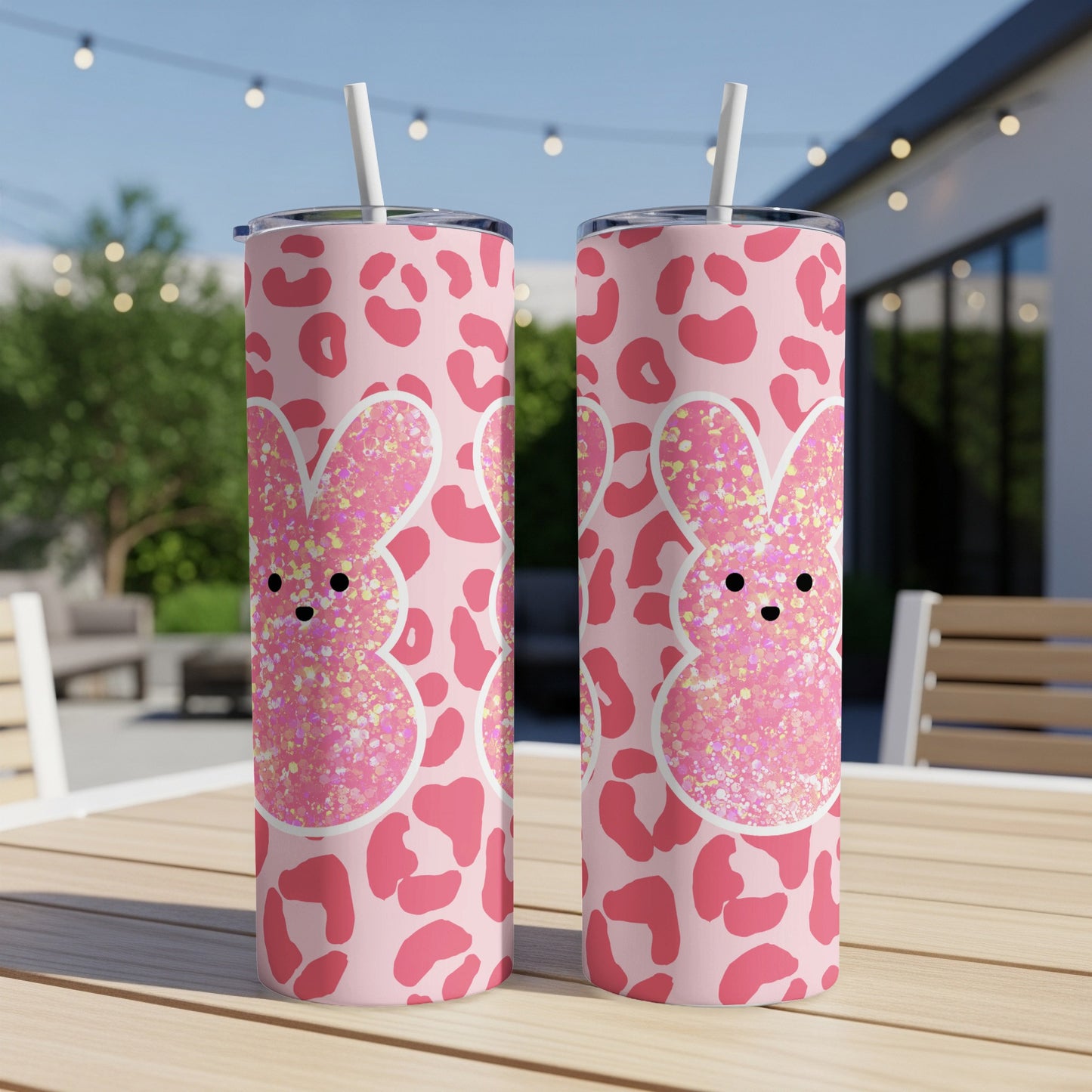 Two pink glitter bunny tumblers with leopard print pattern on a table.
