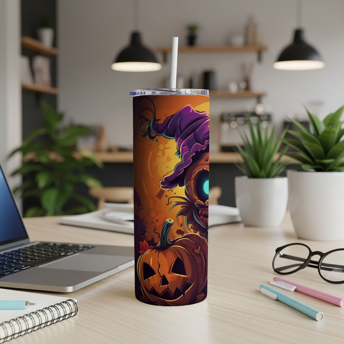 Halloween themed tumbler with pumpkin and witch graphics, including a straw.