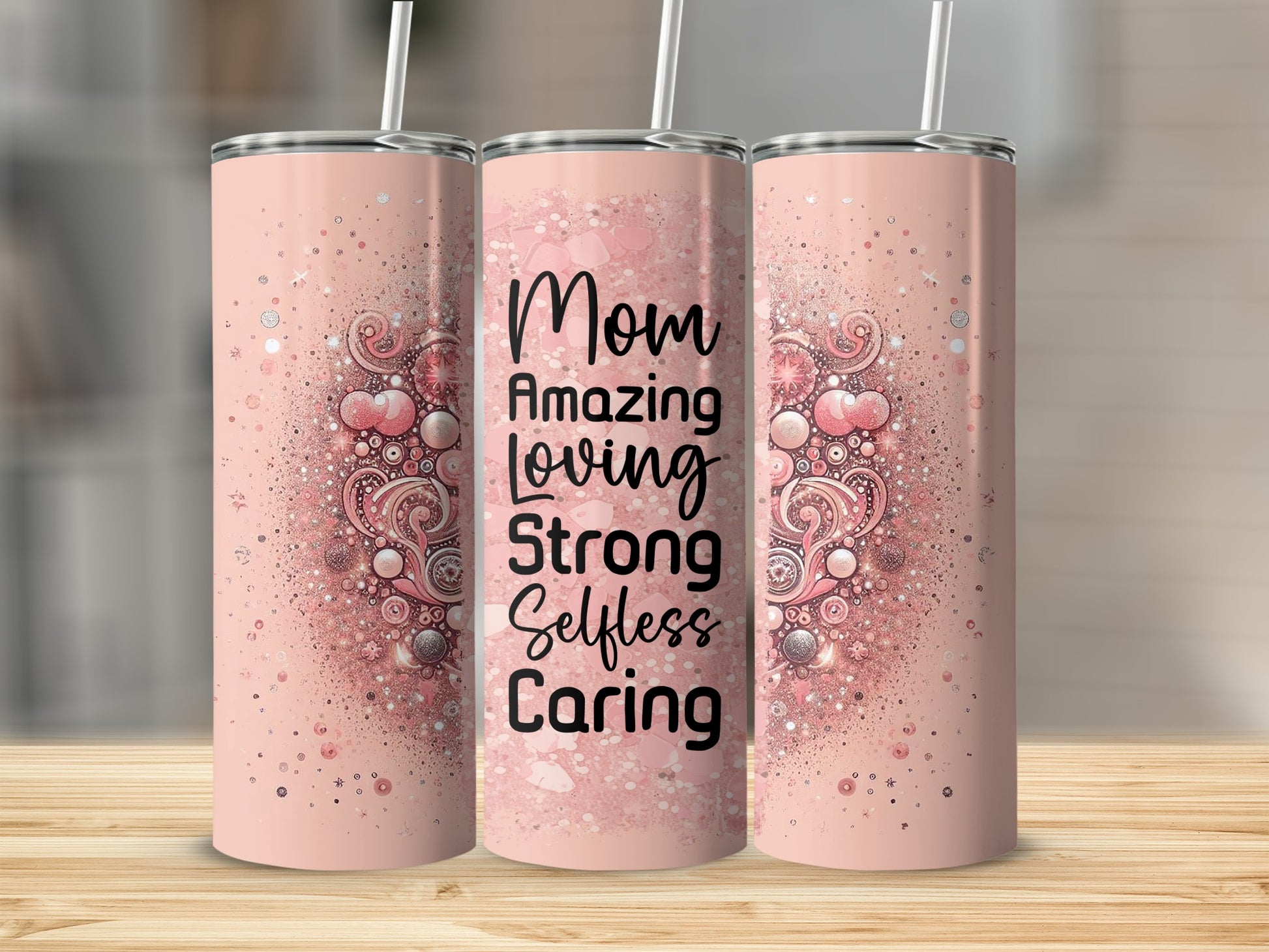 Pink tumbler with "Mom Amazing Loving Strong Selfless Caring" text.
